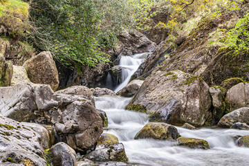 Naklejka na ściany i meble A small rocky stream in Lake District National Park.
