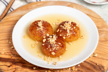 Kemalpasa dessert with milk. Turkish and Middle Eastern cuisine desserts. Ramadan meal. Kemalpaşa dessert on a wooden serving board