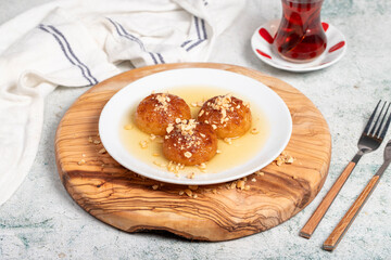 Kemalpasa dessert with milk. Turkish and Middle Eastern cuisine desserts. Ramadan meal. Kemalpaşa dessert on a wooden serving board