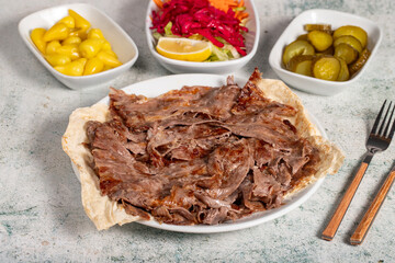 Meat doner kebab. Turkish and Middle Eastern cuisine flavors. Doner kebab on stone floor. Local...