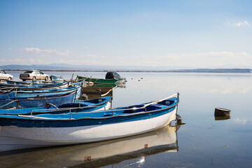 Fototapeta premium Decorated day-trip boats in Işıklı Lake in Denizli's Çivril district. Isıkli Lake is flooded with visitors during lotus time. It is also a popular lake for hunters.