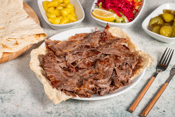 Meat doner kebab. Turkish and Middle Eastern cuisine flavors. Doner kebab on stone floor. Local name tabakta et döner