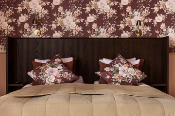Interior of a bedroom with floral wallpaper.