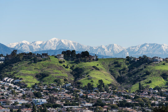 Los Angeles Mt Washington neighborhood with snow capped San Gabriel Mountains peaks in the background.  
