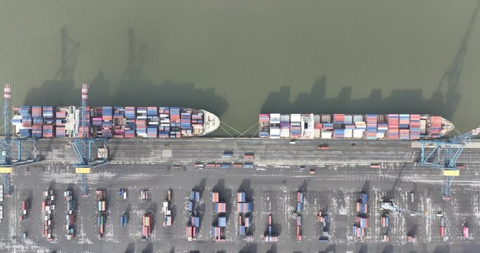 Top down aerial drone view on Waaslandhaven. The Waaslandhaven is the part of the port of Antwerp that is located on the left bank of the Scheldt. Container handling and containers ships.