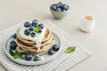 Plate blueberry pancakes with sour cream