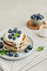 Plate blueberry pancakes with sour cream