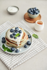 Plate blueberry pancakes with sour cream