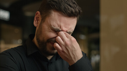 Close up anxious stressed Caucasian man tired upset guy rub dry irritated eyes feel pain ache eye...