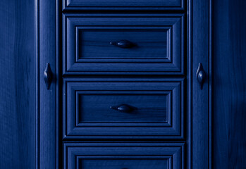 old style wooden chest of drawers background in blue