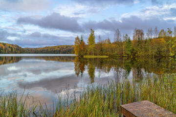 Forest landscape and lake in the northern regions of Russia in late autumn.