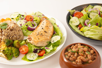 Grilled chicken in a plate with salad and rice isolated clean white background top view photo