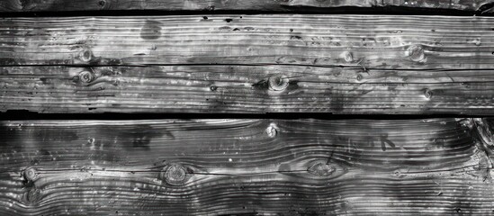 Overhead view of black and white wooden planks arranged in a pattern.