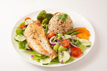 Grilled chicken in a plate with salad and rice isolated clean white background top view photo