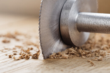 Circular saw cutting wooden plank. Circular milling in oak block.