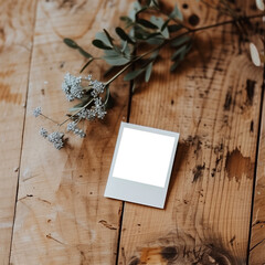 blank instant photos lies on table with a flower mockup / template