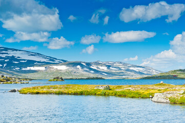 Beautiful landscape with Lake Finsevatnet, snowy mountains and glacier Hardangerjokulen in Finse, Norway