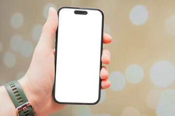 Phone screen mockup. modern smartphone held in hand against bokeh background