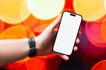 Phone screen mockup. modern smartphone held in hand against bokeh background
