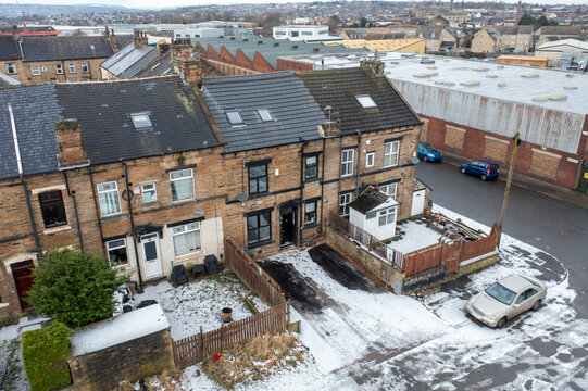 Aerial drone photo of a typical British housing estate in the town of Bradford in the winter time with a small amount of snow on the ground.