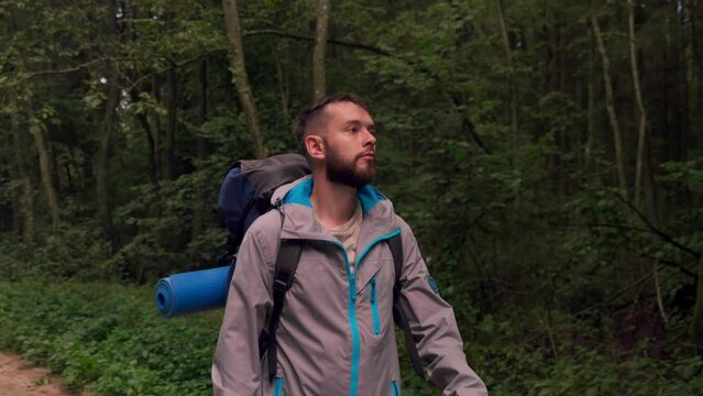 Solo Tourist with backpack Hiking on Adventure Trip in Natural Woods Landscape. slow motion following in front of Walking Person on trail in forest. Inspiring Outdoor Activities travel 