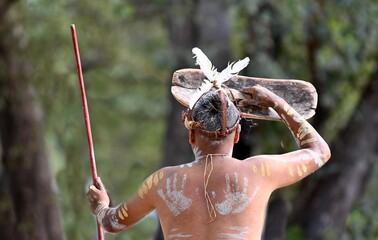 Indigenous Australian man holding weapons on ceremonial dance in Laura Festival Cape York Australia