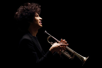 Profile shot of a young man with a trumpet