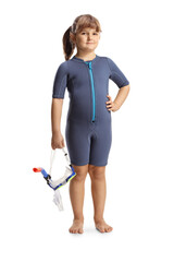 Cute little girl in a wetsuit holding a diving mask