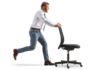 Office worker running and pushing a desk chair