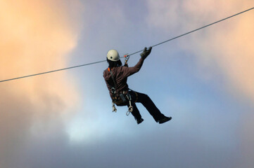 Ziplining through a cloudy sky.  Photographed in South Africa.