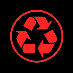 símbolo rojo del reciclaje sobre fondo negro