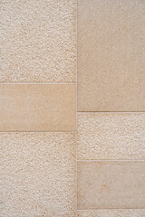 Textured wall divided into distinct sections by visible lines. Left side exhibiting rough texture...