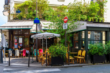 Cozy street with tables of cafe  in Paris, France. Cityscape of Paris. Architecture and landmarks of Paris - 751837836