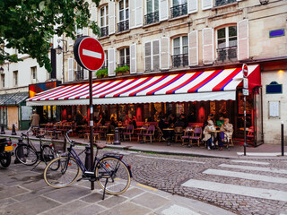 Cozy street with tables of cafe in Paris, France. Cityscape of Paris. Architecture and landmarks of Paris - 751838065