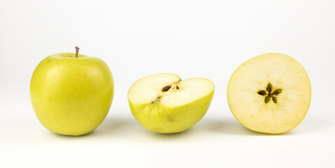 Yellow apples, a whole and two halves of apples on a white background, Apple Banner for your...