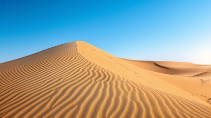 Fototapeta na wymiar Shimmering sand dunes under a clear blue sky