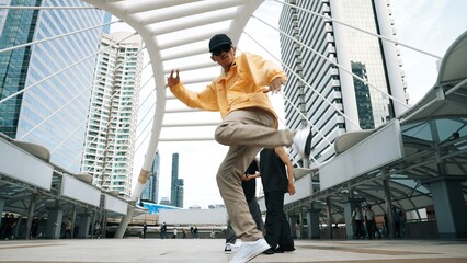 Group of professional street dancer cheer up while asian hipster perform freestyle footstep at city surrounded by people with low angle camera. Break dance concept. Outdoor sport 2024. Sprightly. - obrazy, fototapety, plakaty