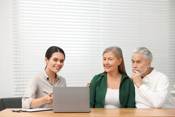Notary consulting senior couple about Last Will and Testament in office