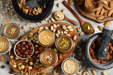 Making nut butters from different nuts. Flat lay composition on light grey table