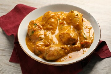 Tasty fresh chicken curry on wooden table