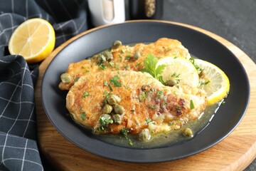 Delicious chicken piccata served on table, closeup