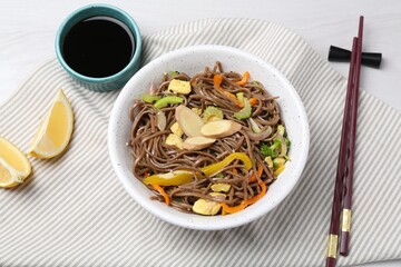 Stir-fry. Delicious cooked noodles with chicken and vegetables in bowl served on light table, flat lay