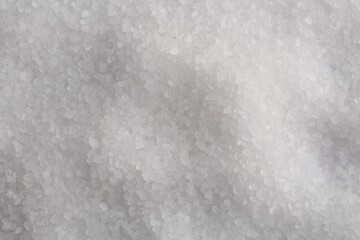 White natural salt as background, top view