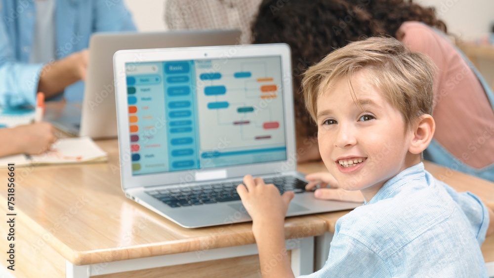 Poster smart caucasian boy looking at camera in stem technology class while group of diverse student and te
