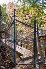A gate at the dam at Malibu Creek State park where people have made a hole to get past the razor...