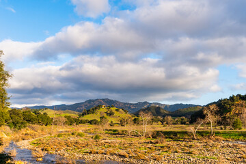 Views mountains, hills, rivers, lush grass and foliage, while hiking during the spring in Malibu Creek State Park.