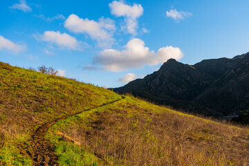 Views mountains, hills, rivers, lush grass and foliage, while hiking during the spring in Malibu Creek State Park.