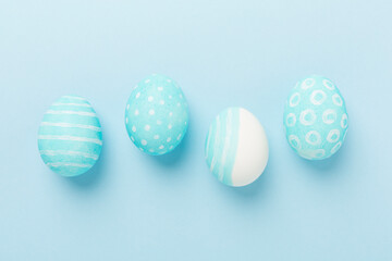Blue easter eggs on color background, top view
