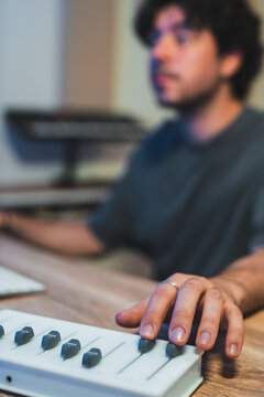 Music producer adjusting audio mixer in studio