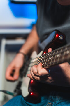 Electric guitar player recording in studio